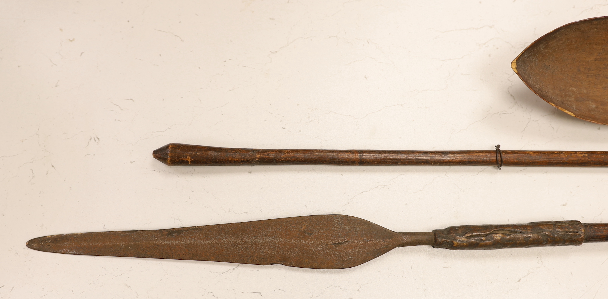 Two African throwing spears and a carved spoon with figural handle, longest spear 132cm